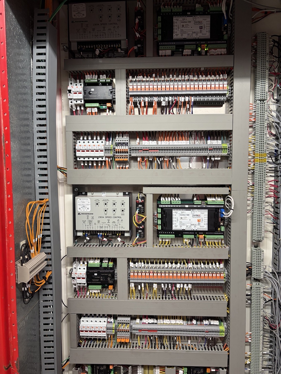 Open engine and generator control cabinet with controllers and wiring