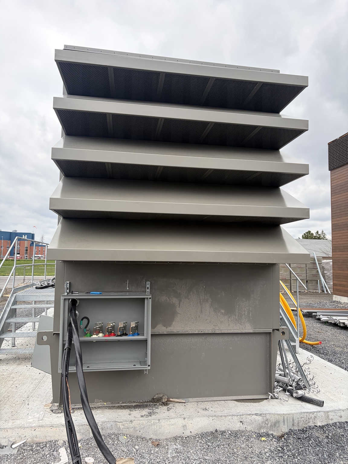 Outdoor louvered electrical equipment enclosure with cable connections